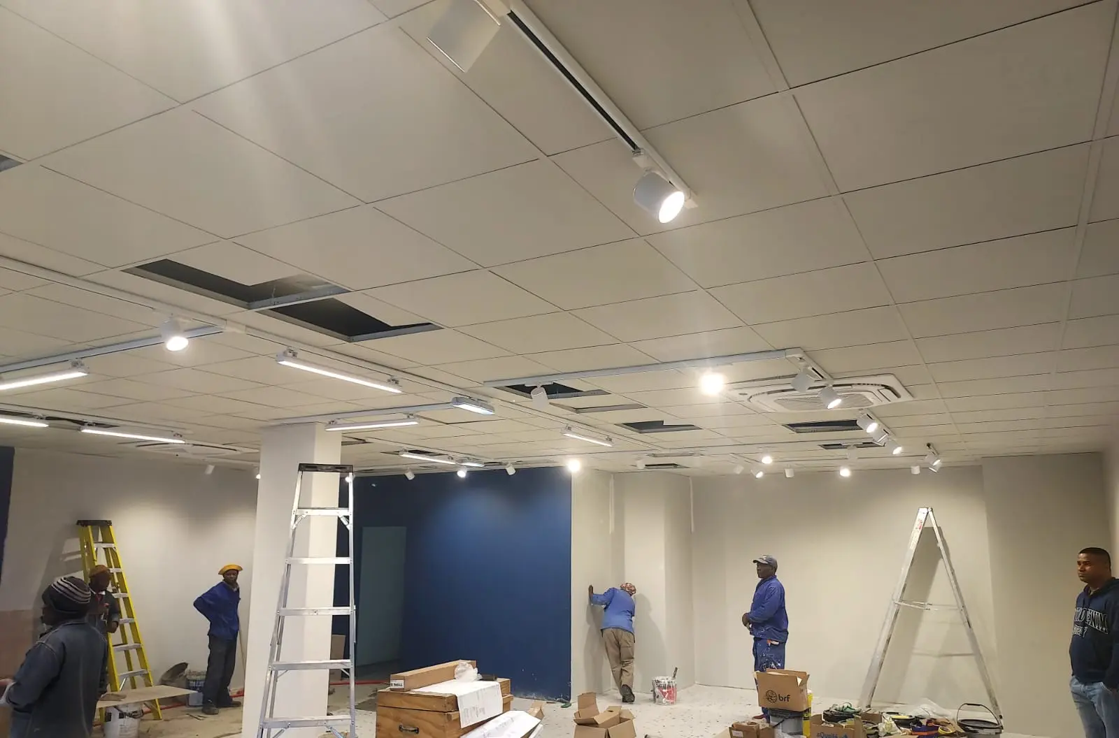 Crew on site, track lighting going in